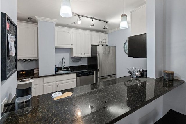 kitchen featuring dark stone countertops, hanging light fixtures, white cabinets, and appliances with stainless steel finishes