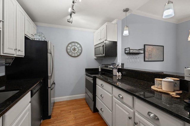 kitchen featuring crown molding, light hardwood / wood-style flooring, hanging light fixtures, white cabinets, and stainless steel appliances