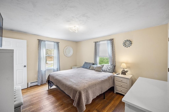239 Upper County Rd, Dennis, MA 02660 - bedroom featuring baseboard heating, multiple windows, and dark wood-type flooring