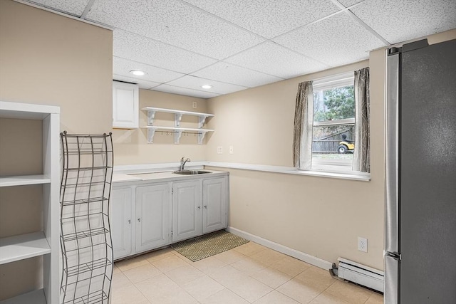 239 Upper County Rd, Dennis, MA 02660 - kitchen with freestanding refrigerator, baseboard heating, open shelves, a paneled ceiling, and light countertops