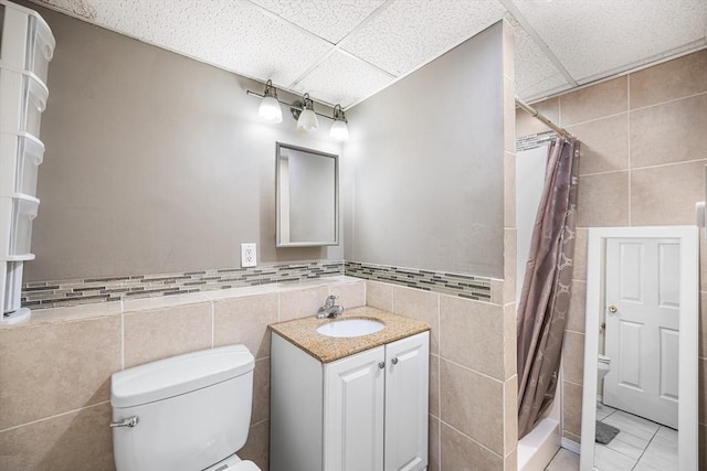 239 Upper County Rd, Dennis, MA 02660 - full bathroom with tile walls, toilet, a drop ceiling, a tile shower, and vanity