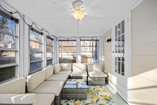 sunroom / solarium with a wealth of natural light and ceiling fan