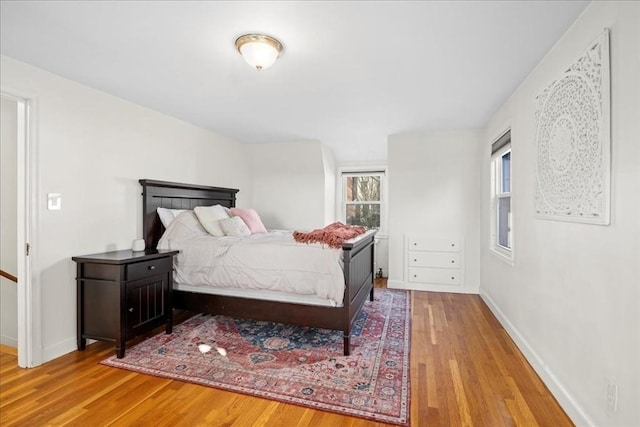 bedroom featuring baseboards and wood finished floors