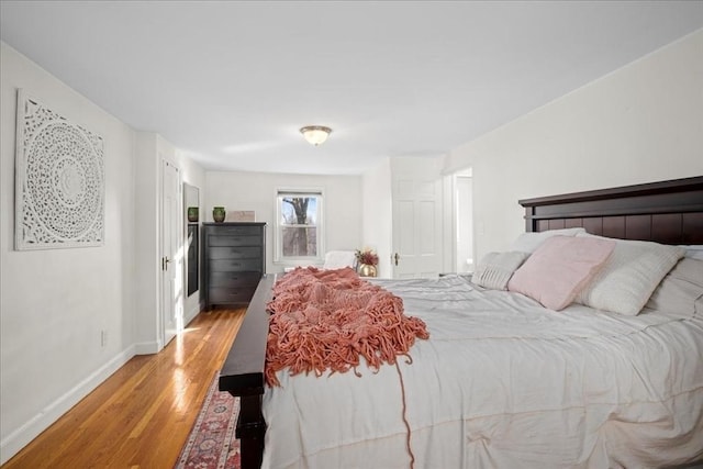 bedroom with light wood-type flooring and baseboards