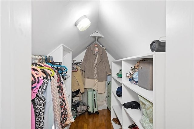 spacious closet with lofted ceiling and wood finished floors