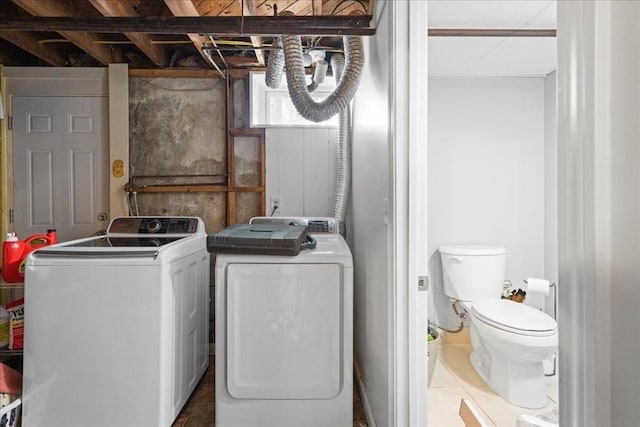 washroom with tile patterned floors, laundry area, and washer and dryer