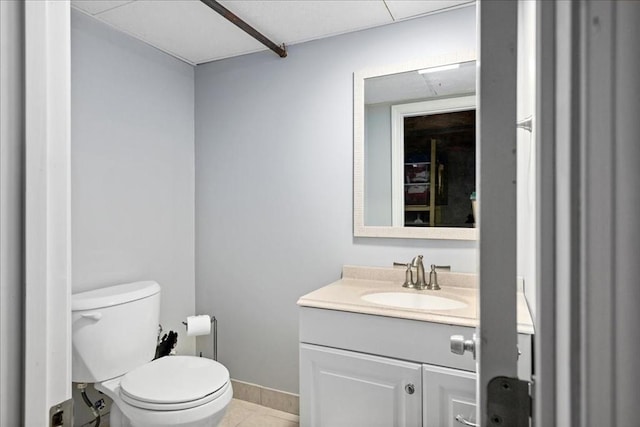 bathroom featuring vanity, tile patterned floors, toilet, and baseboards