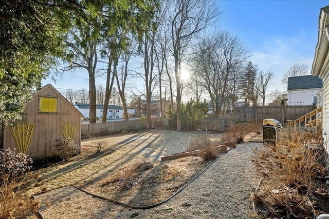 view of yard with an outdoor structure and a fenced backyard