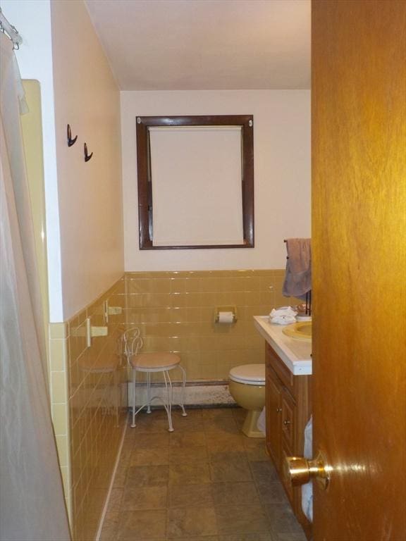 545 Douglas Rd, Northbridge, MA 01588 - full bath featuring tile walls, toilet, vanity, wainscoting, and a shower with shower curtain