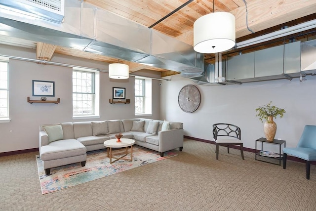 carpeted living area with wooden ceiling and baseboards