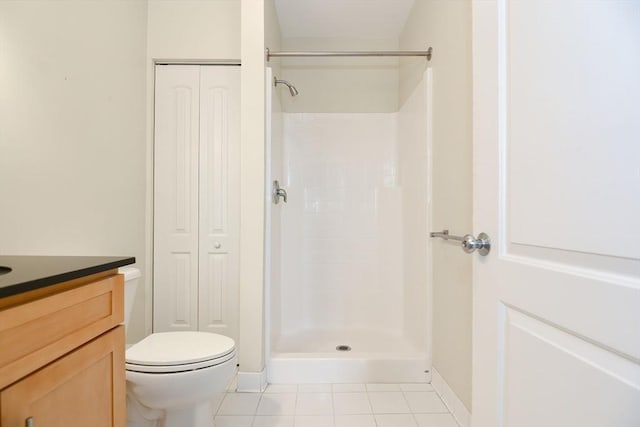 full bath with tile patterned flooring, vanity, toilet, baseboards, and a shower stall