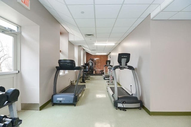 workout area featuring baseboards, visible vents, and a drop ceiling