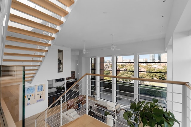 stairway featuring ceiling fan