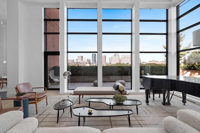 interior space with a towering ceiling, a wealth of natural light, and floor to ceiling windows