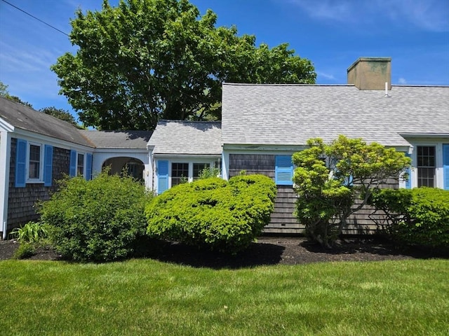 230 Gosnold St Unit 1A, Barnstable, MA 02601 - cape cod-style house with a front yard, a chimney, and roof with shingles