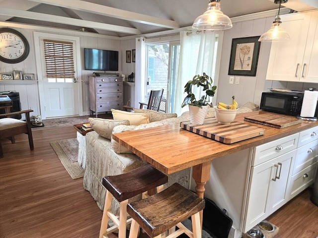 230 Gosnold St Unit 1A, Barnstable, MA 02601 - dining space featuring dark wood-style flooring and a decorative wall