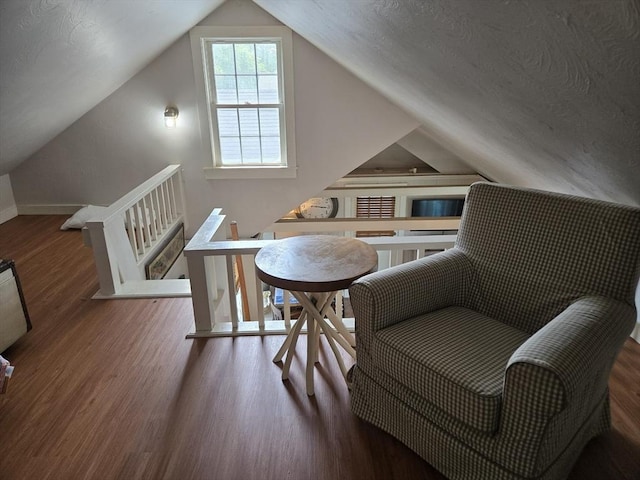 230 Gosnold St Unit 1A, Barnstable, MA 02601 - sitting room with wood finished floors, an upstairs landing, lofted ceiling, and baseboards