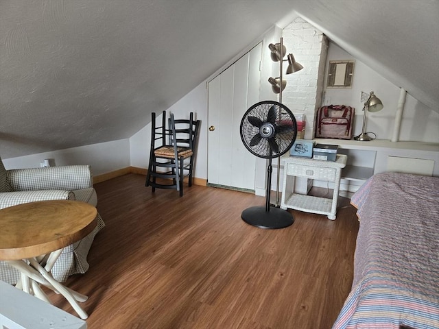 230 Gosnold St Unit 1A, Barnstable, MA 02601 - bedroom featuring wood finished floors, lofted ceiling, baseboards, and a textured ceiling