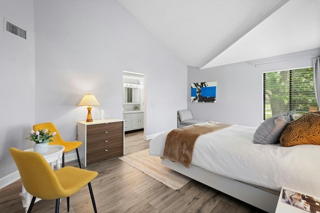 243 Trailside Way Unit 243, Ashland, MA 01721 - bedroom with baseboards, wood finished floors, ensuite bath, and high vaulted ceiling