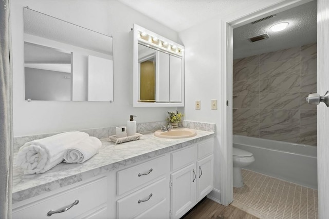 243 Trailside Way Unit 243, Ashland, MA 01721 - bathroom with toilet, vanity, a textured ceiling, and shower / bathtub combination