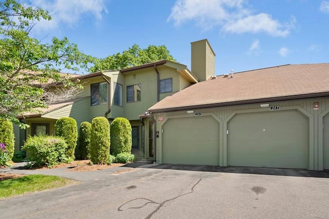 243 Trailside Way Unit 243, Ashland, MA 01721 - townhome / multi-family property featuring an attached garage, a chimney, and driveway