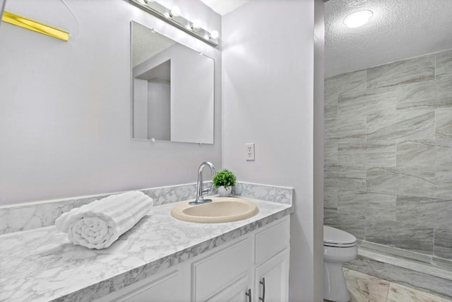 243 Trailside Way Unit 243, Ashland, MA 01721 - full bath with vanity, a textured ceiling, toilet, and a tile shower