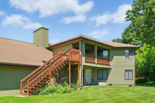 243 Trailside Way Unit 243, Ashland, MA 01721 - rear view of property featuring stairs, a lawn, and a chimney