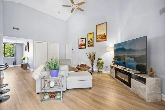 243 Trailside Way Unit 243, Ashland, MA 01721 - living area featuring ceiling fan, high vaulted ceiling, light wood finished floors, and baseboards