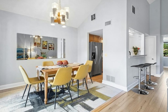 243 Trailside Way Unit 243, Ashland, MA 01721 - dining room with high vaulted ceiling, a chandelier, light wood-type flooring, and baseboards