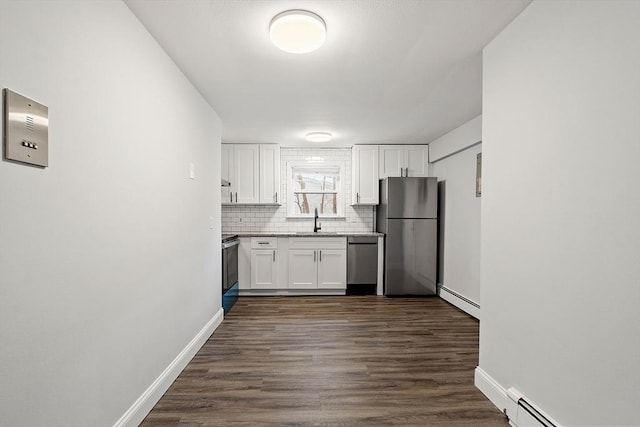 kitchen with sink, a baseboard radiator, white cabinets, and stainless steel appliances