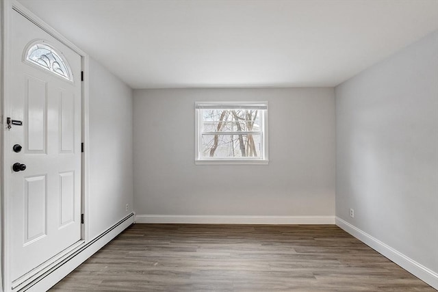 entrance foyer with a baseboard heating unit and light hardwood / wood-style floors