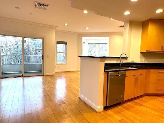 kitchen featuring ornamental molding, visible vents, a sink, and stainless steel dishwasher