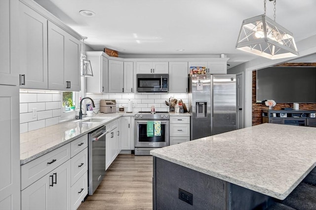 29 Edgemere Dr, Seekonk, MA 02771 - kitchen with stainless steel appliances, tasteful backsplash, light wood-style floors, hanging light fixtures, and white cabinets