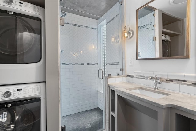 13 Maryland St Unit 2, Boston, MA 02125 - bathroom featuring vanity, stacked washer / dryer, and a stall shower