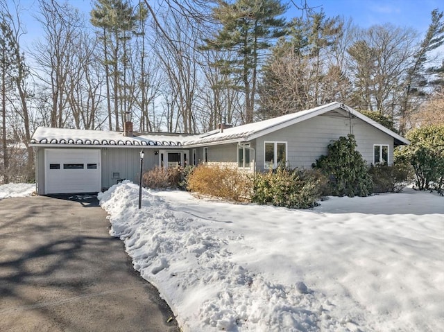 ranch-style home featuring driveway and an attached garage