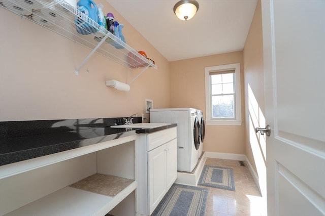 laundry area featuring cabinets, sink, and washing machine and dryer