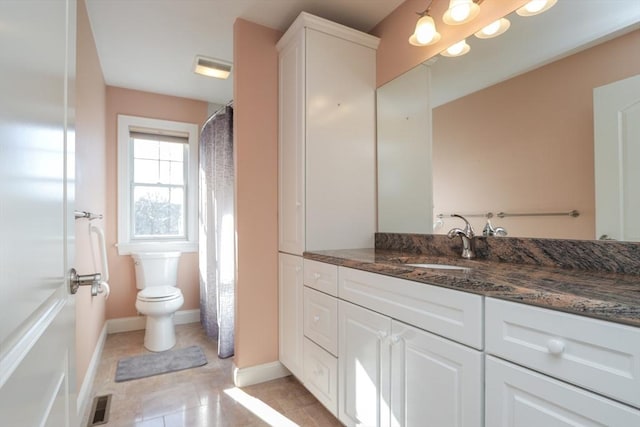 bathroom with tile patterned floors, vanity, and toilet