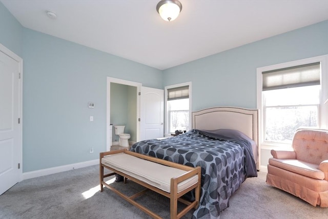 bedroom featuring multiple windows, carpet, and connected bathroom