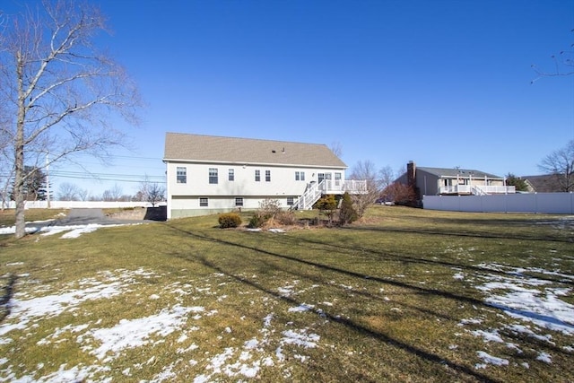 snow covered property featuring a yard