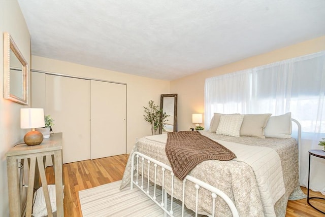 bedroom with a closet and wood finished floors