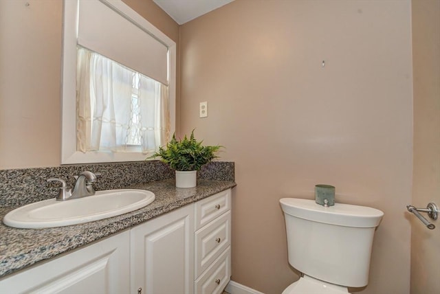 half bath featuring toilet and vanity