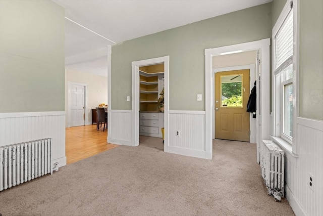 426 Moraine St, Brockton, MA 02301 - carpeted empty room featuring radiator and a wainscoted wall