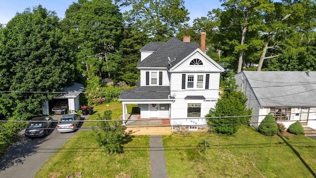 426 Moraine St, Brockton, MA 02301 - victorian-style house with covered porch, a chimney, a shingled roof, and view of scattered trees