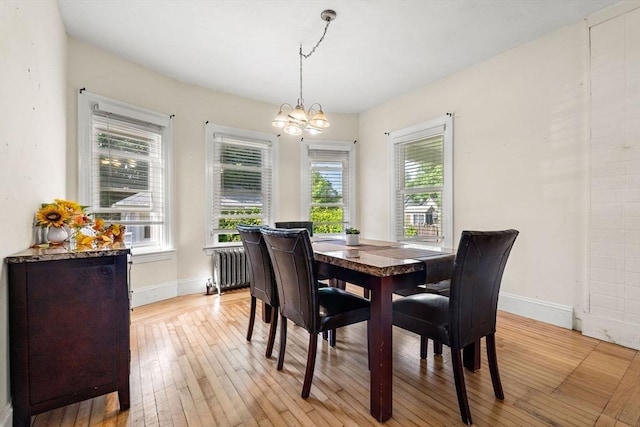 426 Moraine St, Brockton, MA 02301 - dining room with radiator, light wood-type flooring, and a chandelier
