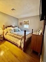 bedroom with dark wood-style flooring