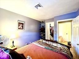 bedroom featuring visible vents