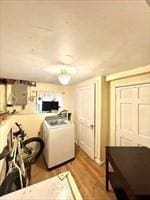 kitchen with washer / clothes dryer, light countertops, and wood finished floors