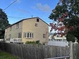 view of side of property featuring fence