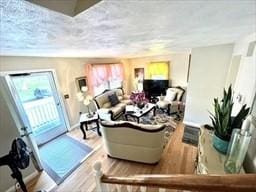 living area featuring baseboards and wood finished floors