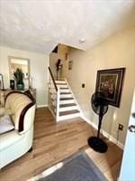 workout room featuring baseboards and wood finished floors